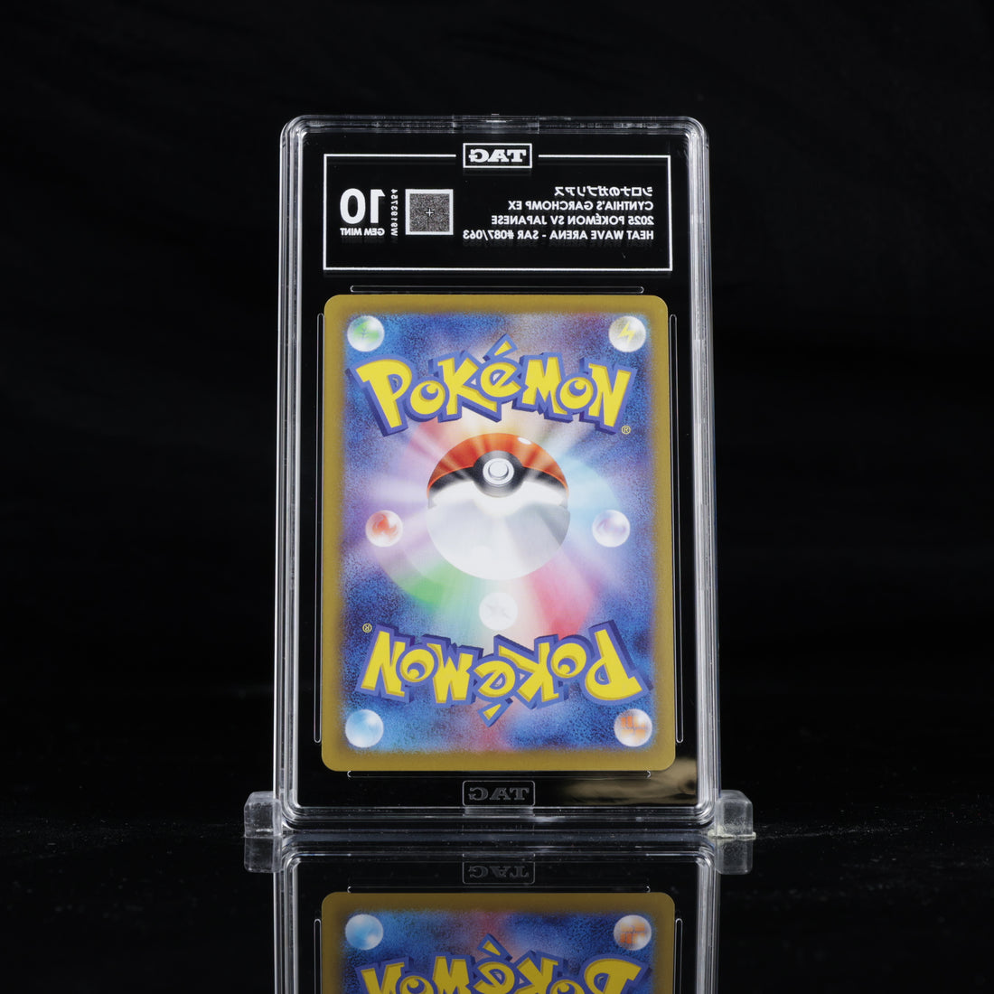 Back view of TAG slab containing Cynthia’s Garchomp EX SAR 087/063 Japanese Pokémon card, showing the official Pokémon card back design and TAG grading label with GEM MINT 10 grade. 1x1