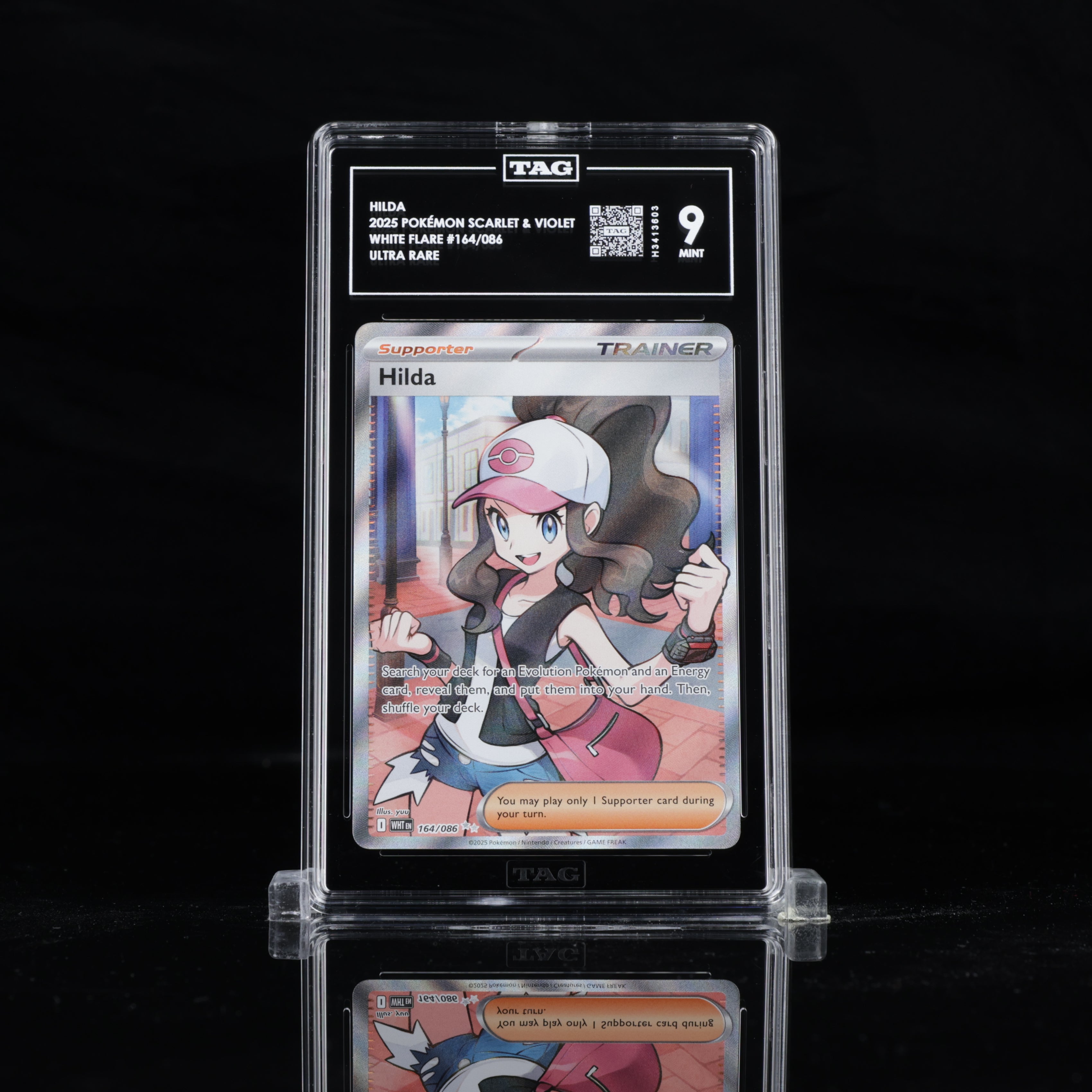 Front view of Hilda 164/086 English Ultra Rare Pokémon card from Scarlet & Violet: White Flare — TAG graded 9 (Mint), encapsulated in a crystal-clear TAG slab with full card artwork visible.