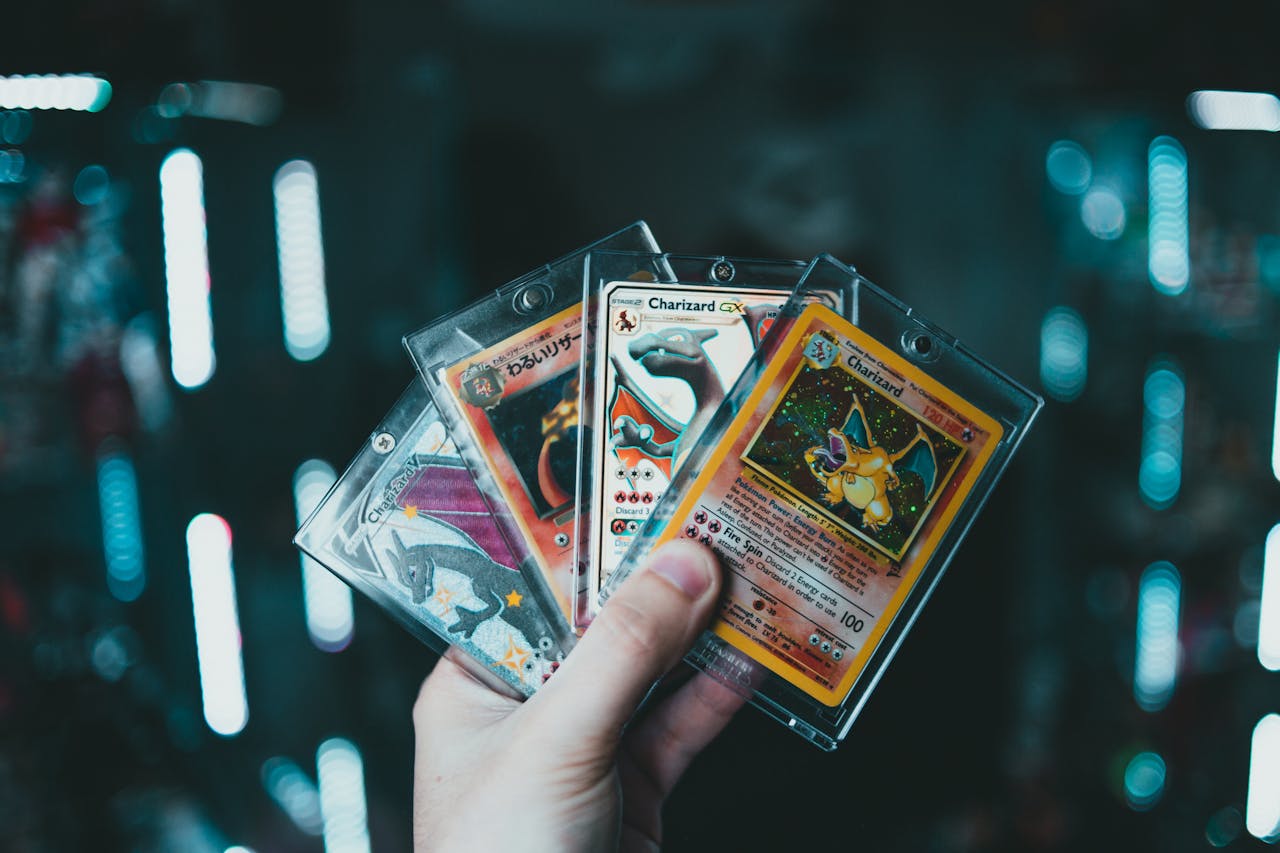 holding Pokémon cards charizard and shiny charizard ENGLISH AND JAPANESE POKEMON CARDS | JAYS POKE HUB 
